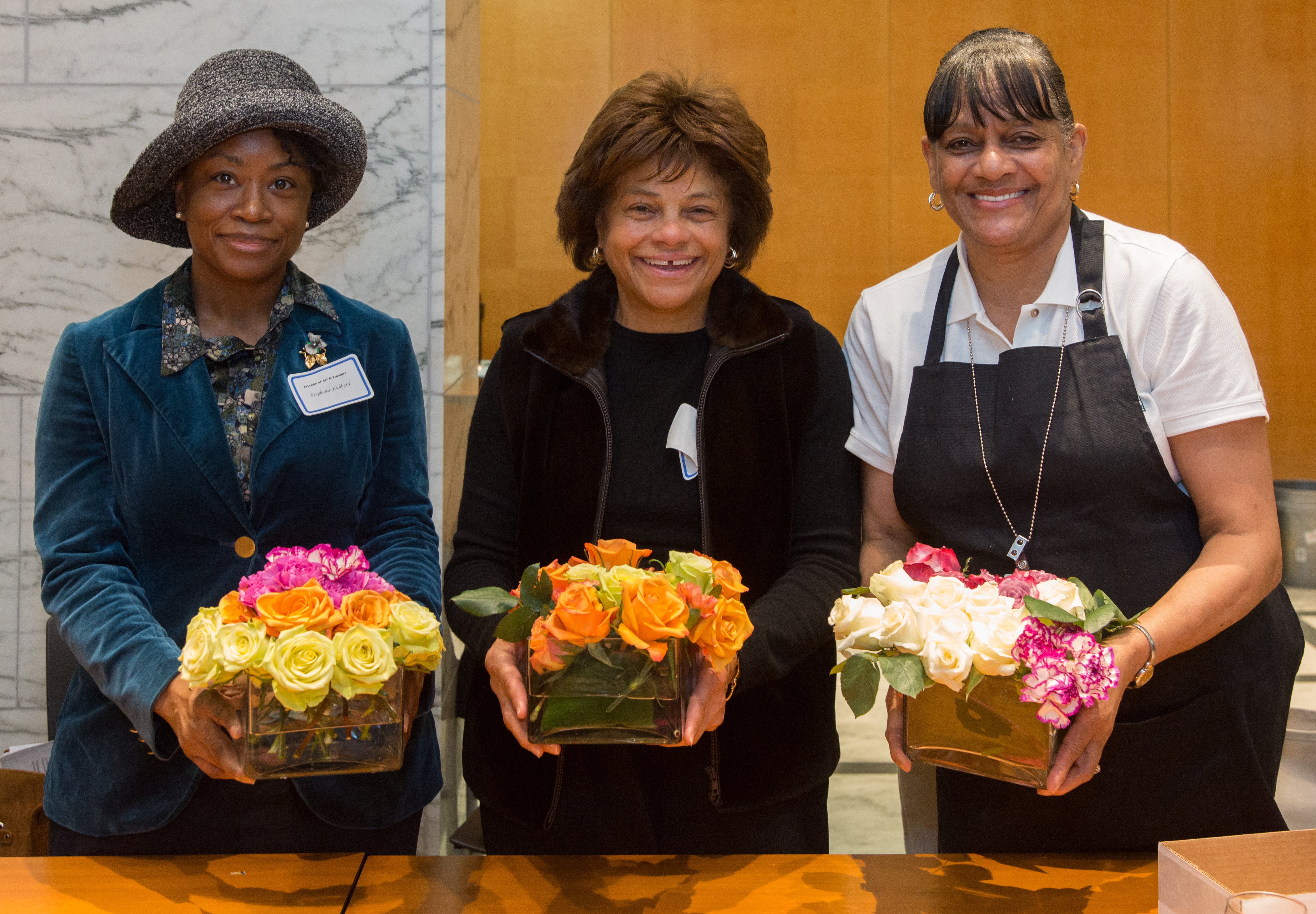 Members of Friends of Art & Flowers displaying their floral arrangements