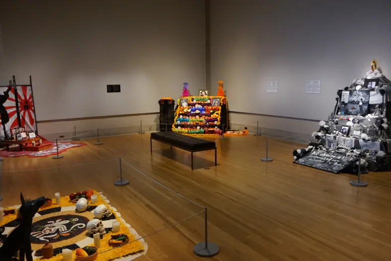 One room of the 2022 Ofrendas exhibition, featuring five Ofrendas altars