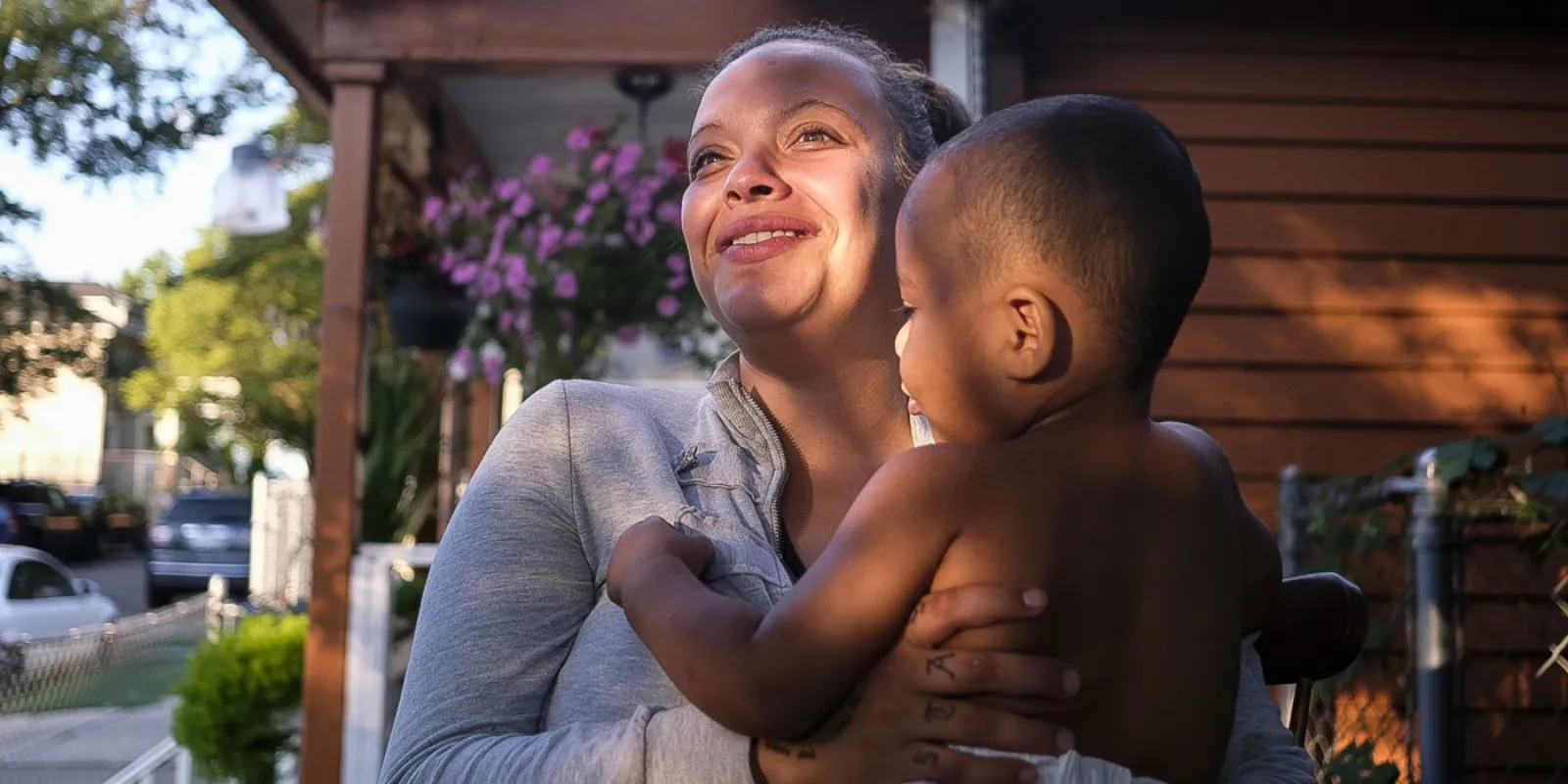 Ashley holds her son Nathaniel on the front porch