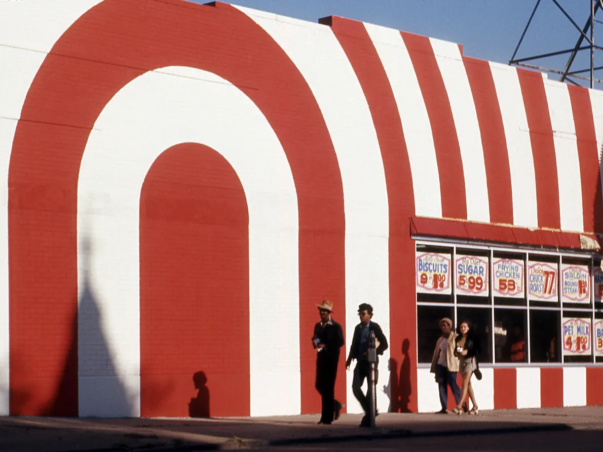 “Untitled (Red and White Striped Storefront with Passersby),” around 1970, attributed to Allen Stross, color transparency film. Detroit Institute of Arts
